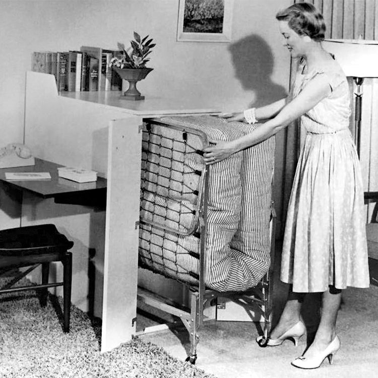 A woman in the 1950's demonstrates how to operate a hide-a-bed.