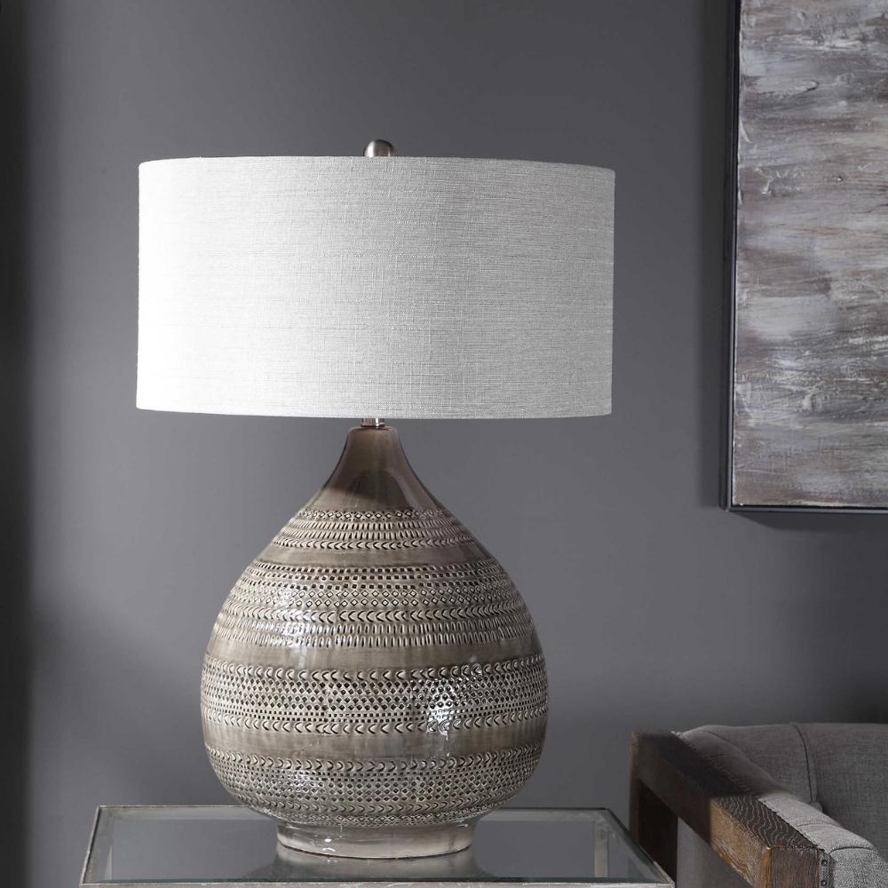 grey ceramic tear-drop shaped lamp with white drum shade.