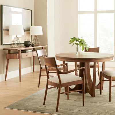 stickley walnut grove dining scene with round dining table, four matching chairs, and console table.