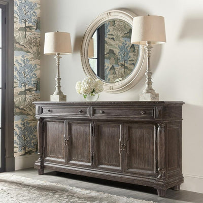 traditional dark wood buffet against wall with two lamps on top and mirror above