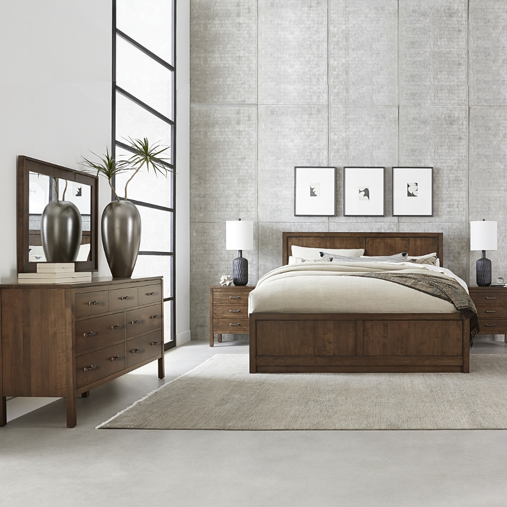 stickley origins dwyer bedroom scene with brown wood bed, nightstands, dresser, and mirror