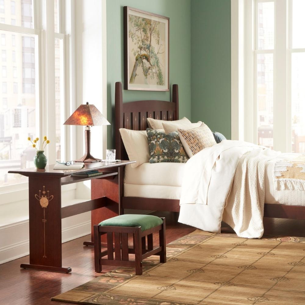 stickley harvey ellis bedroom scene with console desk, footstool, and bed