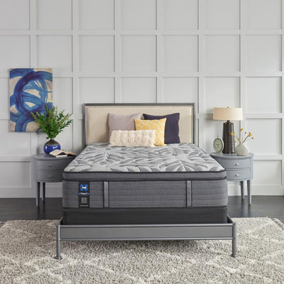 sealy brand mattress on grey bedframe flanked by two matching grey nightstands