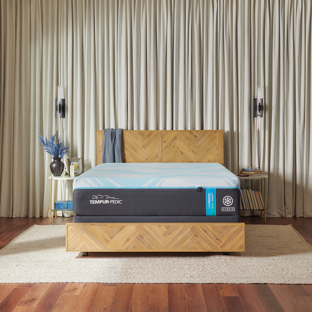 tempur-pedic mattress on a bed frame in large room scene with nightstands