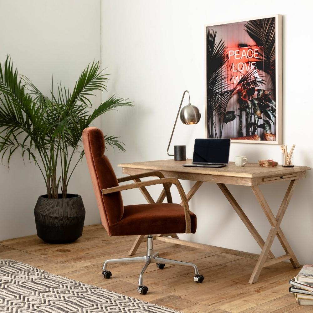 burnt orange velvet office chair sitting at modern light wood desk