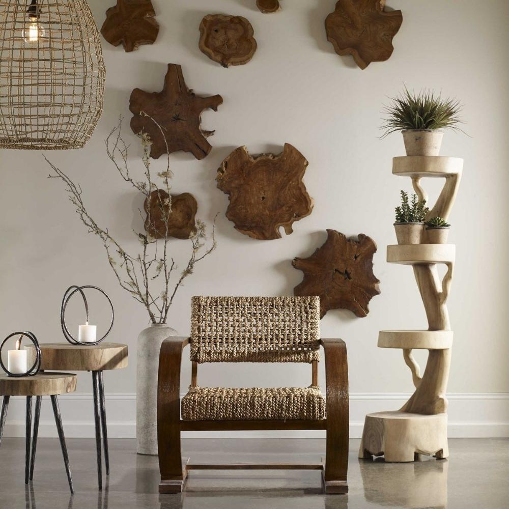 wood wall art on wall behind modern arm chair and side tables