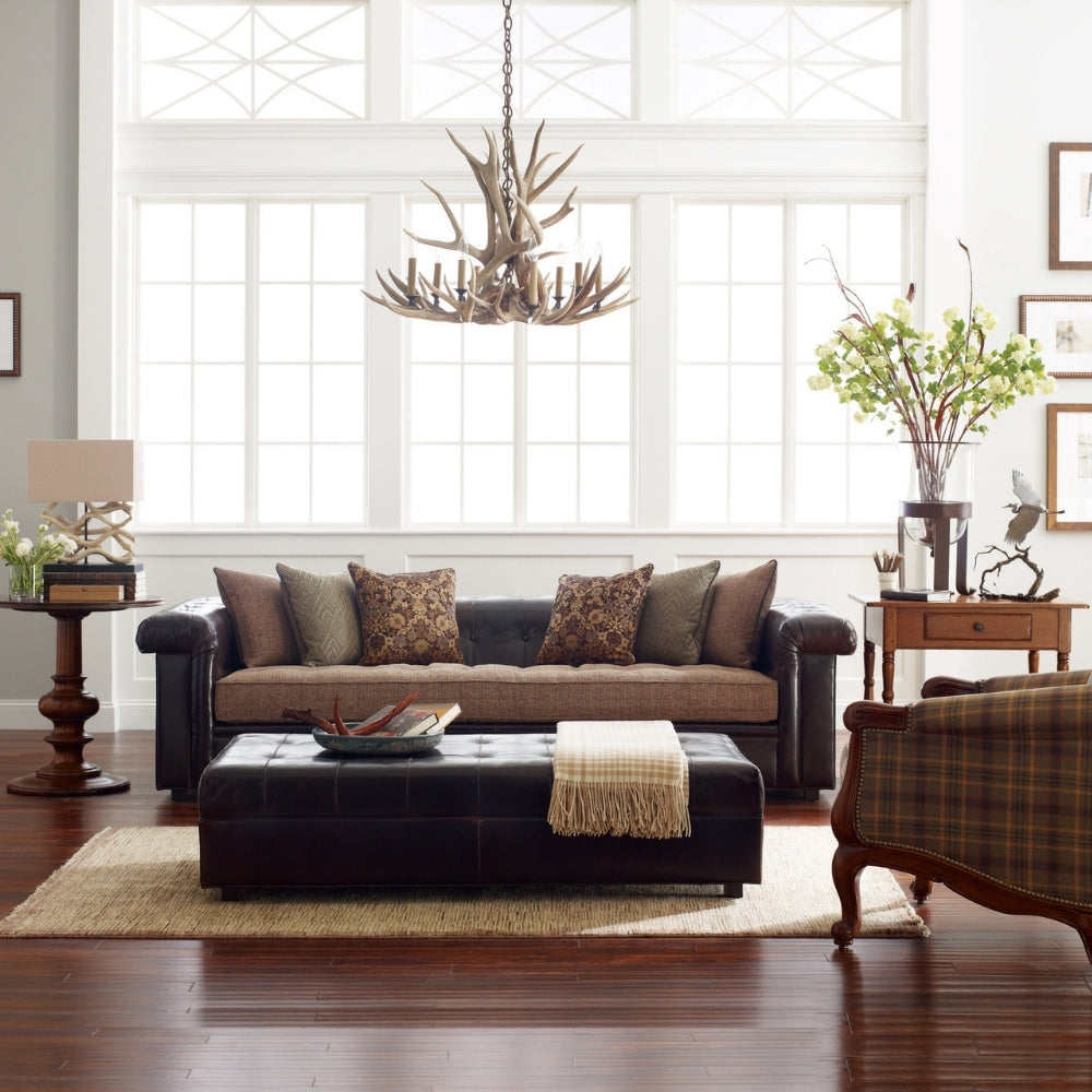 living room scene with large leather and fabric sofa behind leather cocktail ottoman