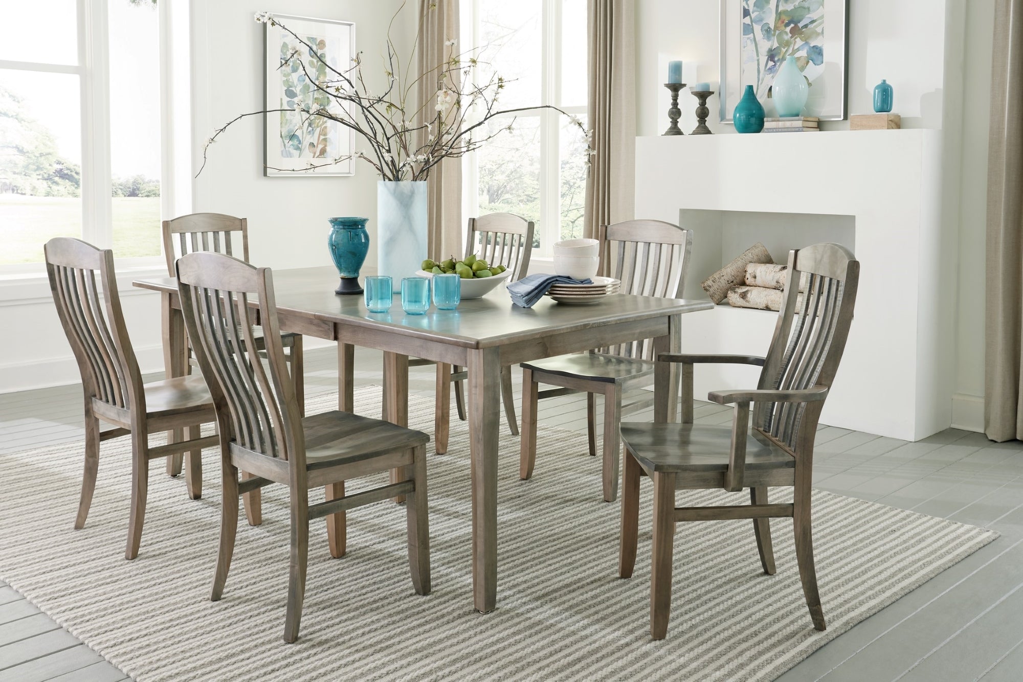 grey finished wood rectangle dining table surrounded by six matching wood dining chairs