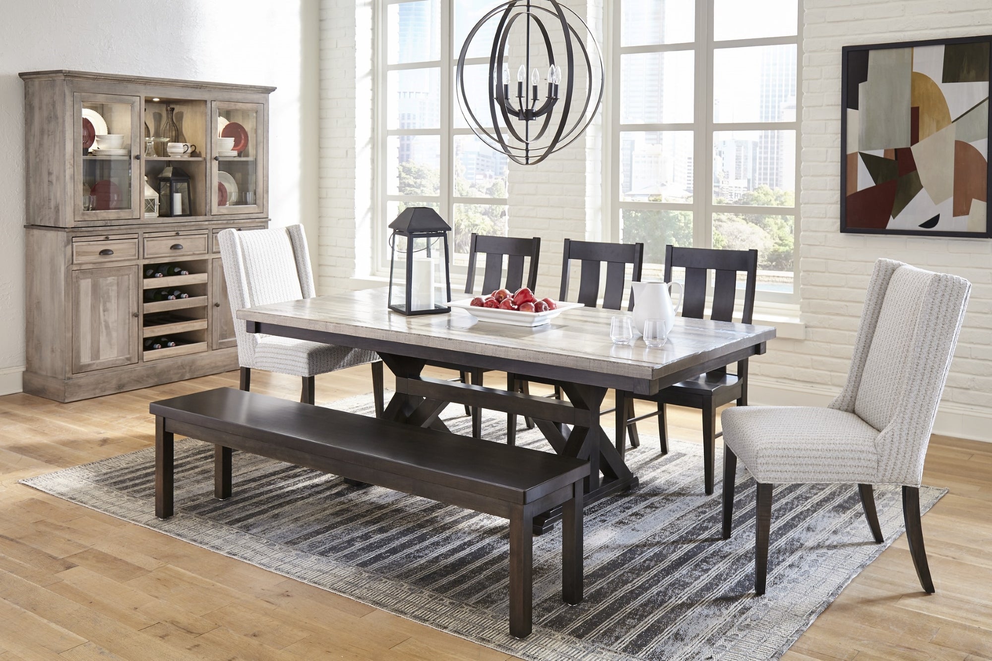 Farmhouse style dining room with a two-tone dining table, dark wood dining bench, and matching dining chairs.