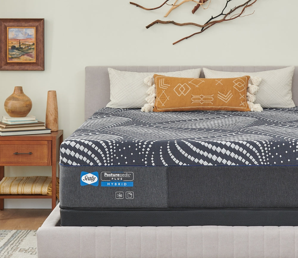 close-up of brand label on a Sealy mattress in a bedroom scene.