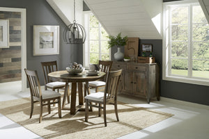 Small dining area with a round, wood dining table surrounded by four matching dining chairs