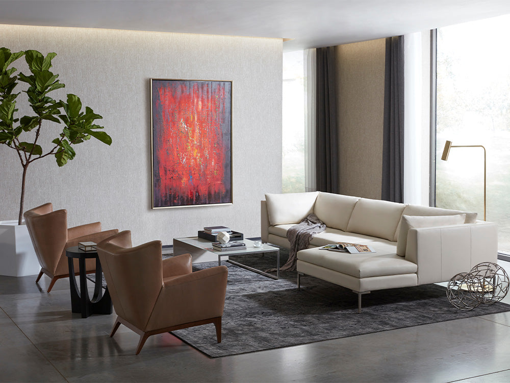 American Leather living room scene featuring a white leather sectional sofa with two tan leather arm chairs.
