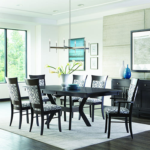 Black, modern dining table surrounded by matching upholstered dining chairs.