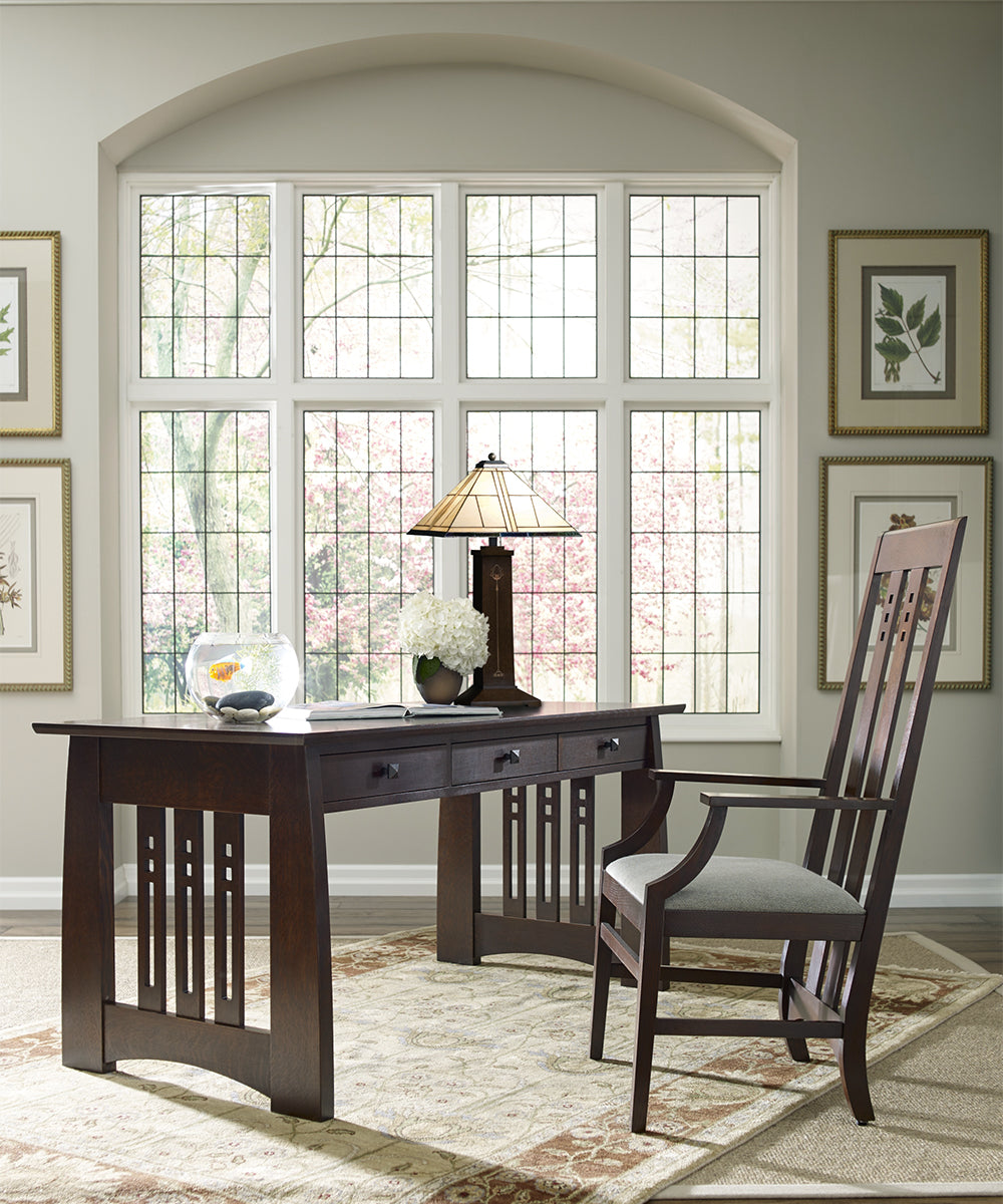 A dark wood desk with matching chair from Stickley's Highlands collection.