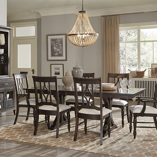 traditional dark wood dining table surrounded by matching dining chairs