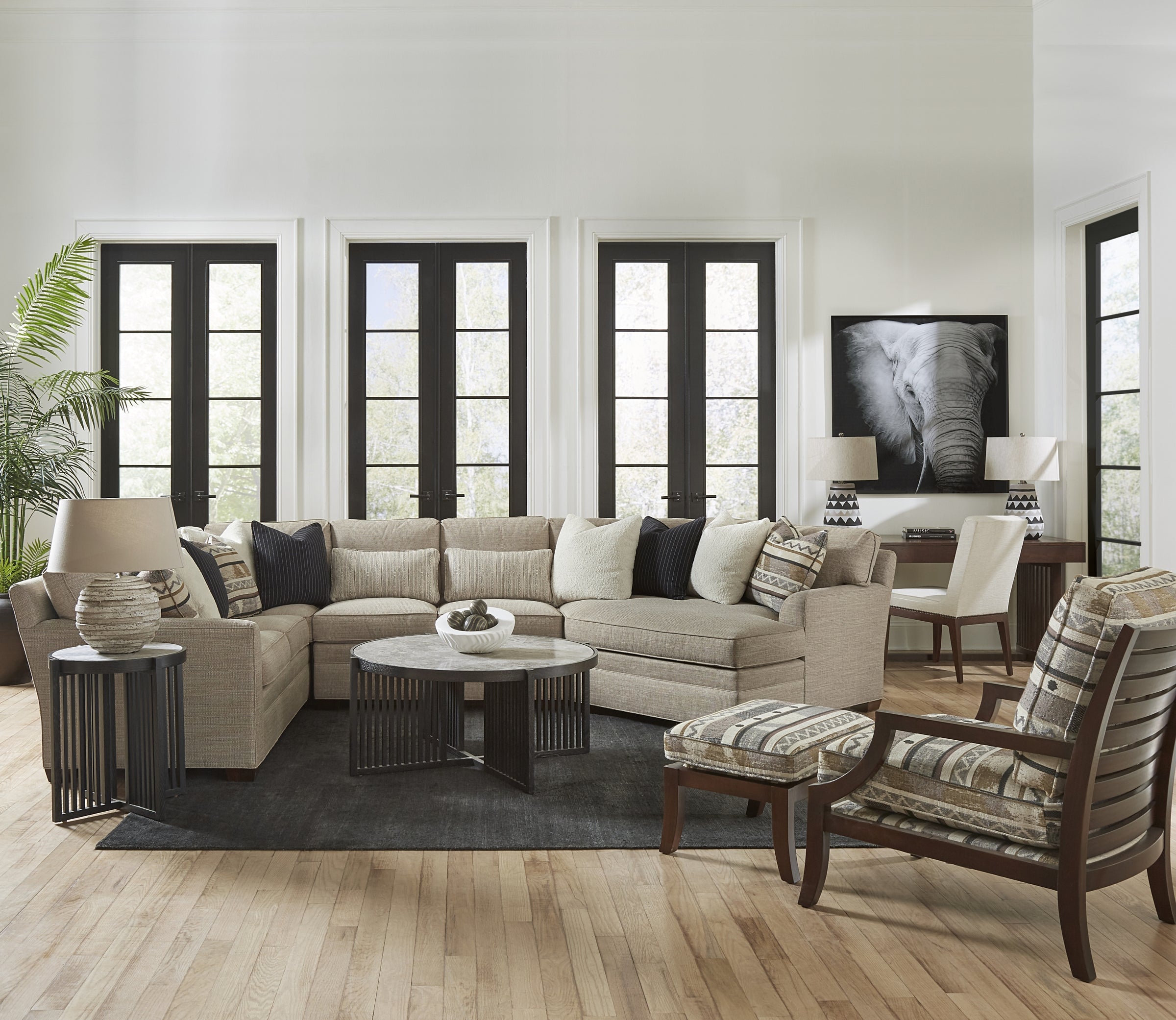 A large configuration of Stickley's 7000 series sectionals with a dark wood coffee table and side table.
