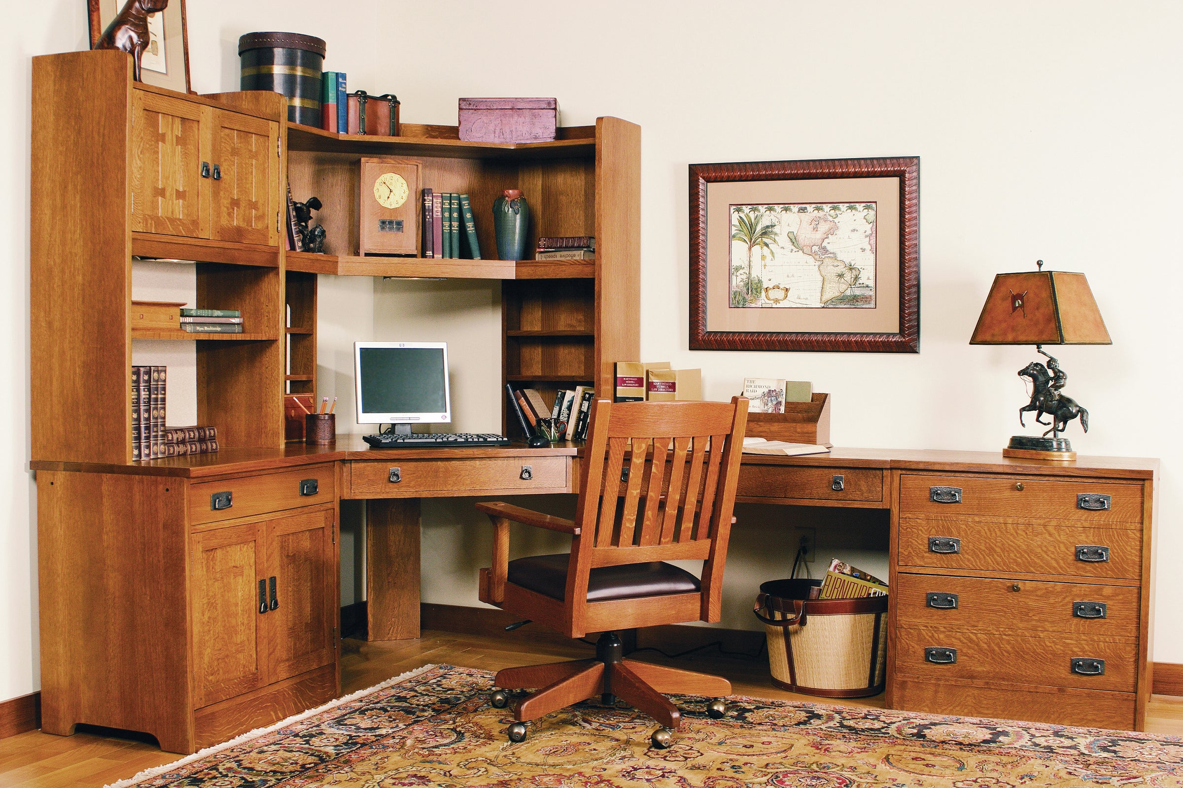 Traditional home office scene with a large computer credenza, file cabinet, and wood desk chair with a leather seat.