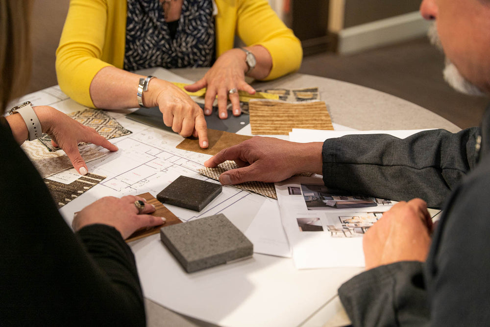 birds eye view of design plan with people's arms at seldens tacoma showroom
