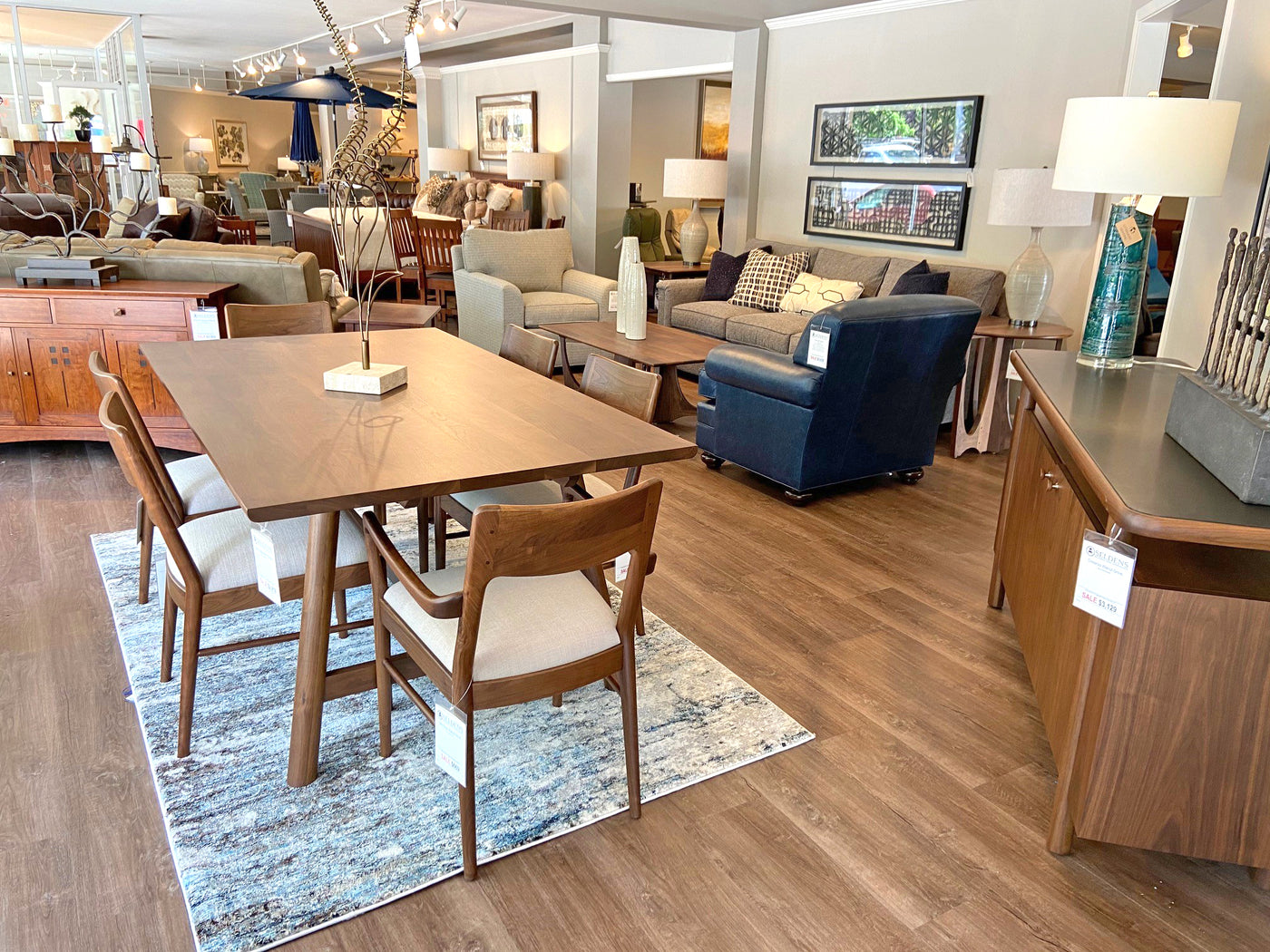 A dining room and living room setup in the Seldens furniture showroom in Olympia, Washington.