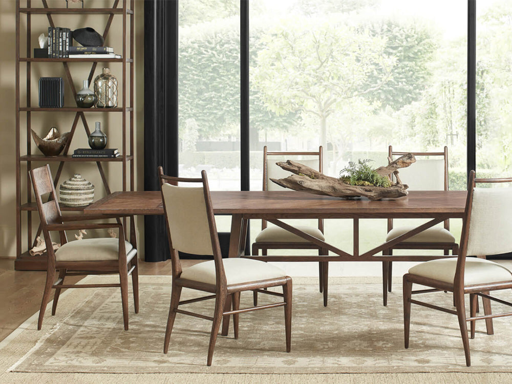 A dining room scene from Theodore Alexander featuring a dining table and matching chairs from the Nova collection.
