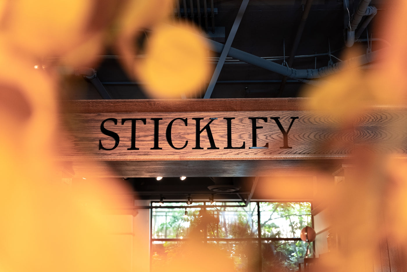 View of the Stickley brand sign through fake flowers in the Seldens furniture showroom in Bellevue, Washington.