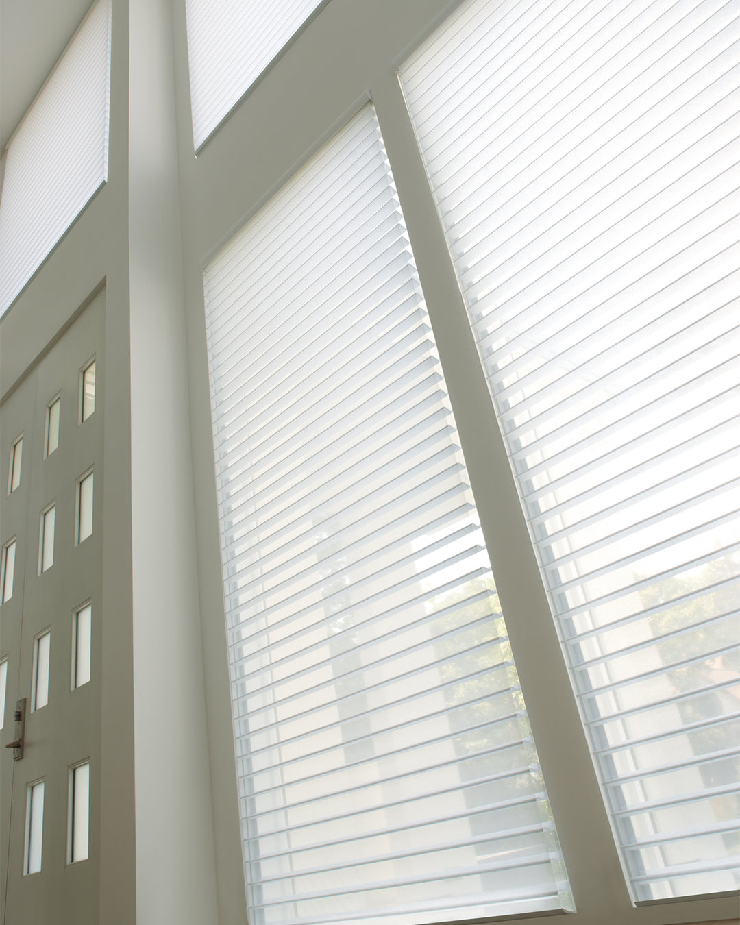 Windows with sheer white blinds