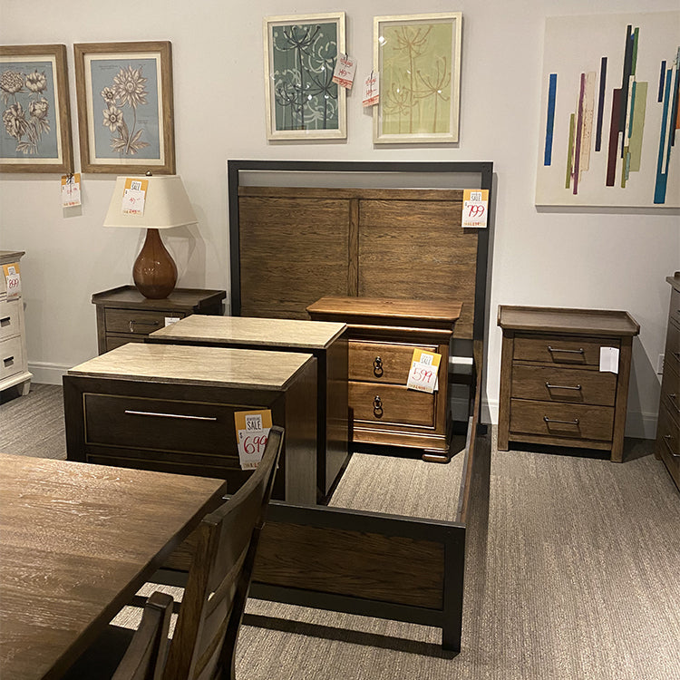Seldens Sleep Gallery Remodel Clearance Sale room with various bedroom furniture including a wood bed frame and wood nightstands