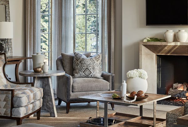 Living room scene with two chairs and a coffee table from Theodore Alexander furniture company.